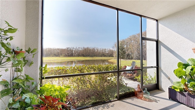 unfurnished sunroom with a water view and a wealth of natural light