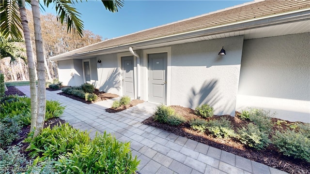 view of exterior entry featuring a patio area