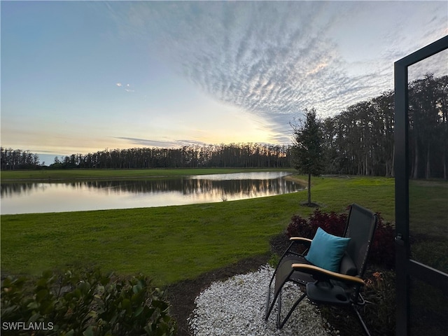 yard at dusk with a water view