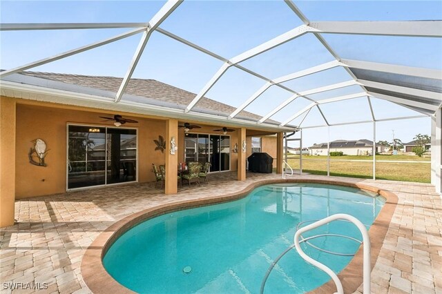 view of pool featuring grilling area, ceiling fan, glass enclosure, and a patio area