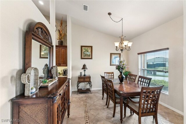 tiled dining area featuring vaulted ceiling and an inviting chandelier