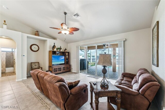 living room with light tile patterned flooring, lofted ceiling, and ceiling fan