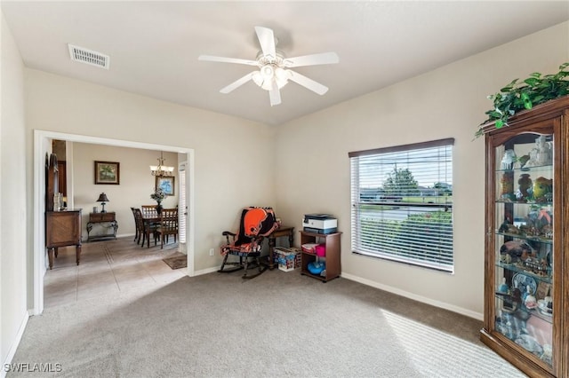 misc room with ceiling fan with notable chandelier and carpet flooring