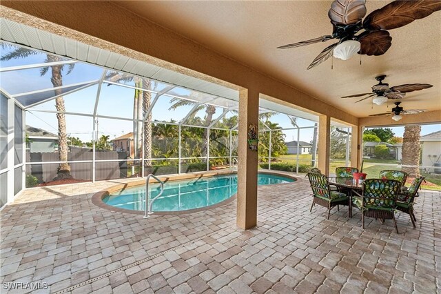 view of swimming pool featuring a lanai, a patio area, and ceiling fan