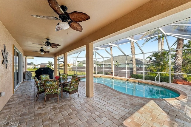 view of swimming pool featuring area for grilling, a lanai, and a patio