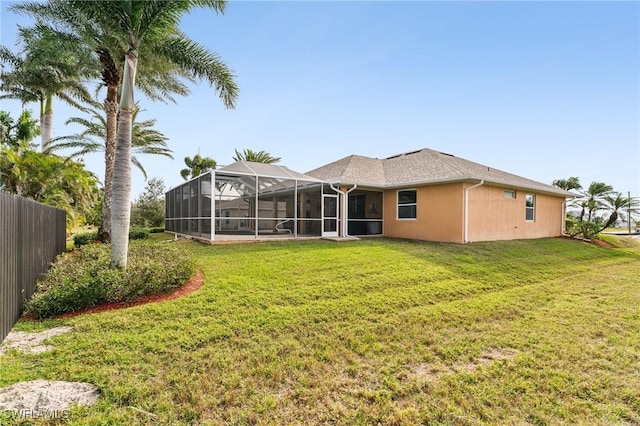 back of property featuring a yard and a lanai