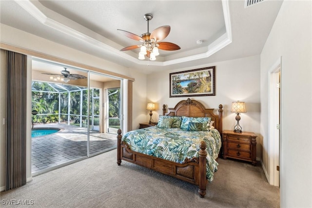 carpeted bedroom with access to outside, ceiling fan, and a tray ceiling