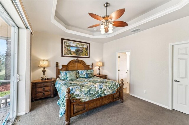 carpeted bedroom with ceiling fan, access to exterior, and a raised ceiling