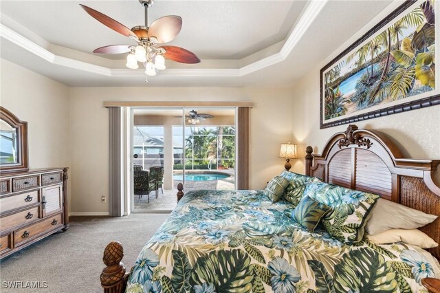 bedroom featuring light carpet, access to exterior, a raised ceiling, and ceiling fan