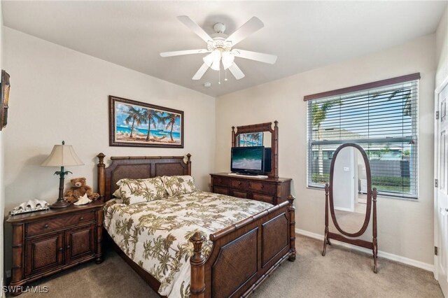 bedroom with light carpet and ceiling fan