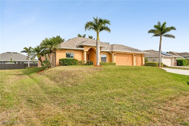 view of front of property with a garage and a front yard