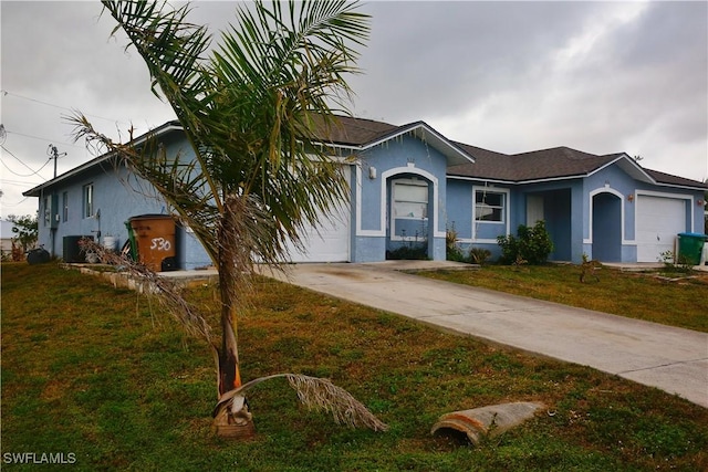 single story home with a garage and a front yard