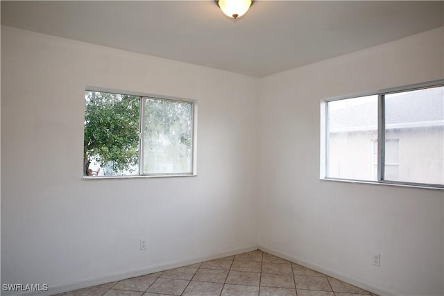 unfurnished room featuring light tile patterned floors