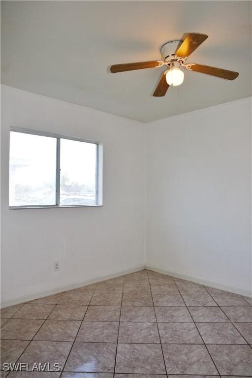 empty room featuring ceiling fan and light tile patterned floors