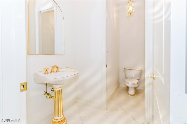 bathroom with toilet and tile patterned flooring