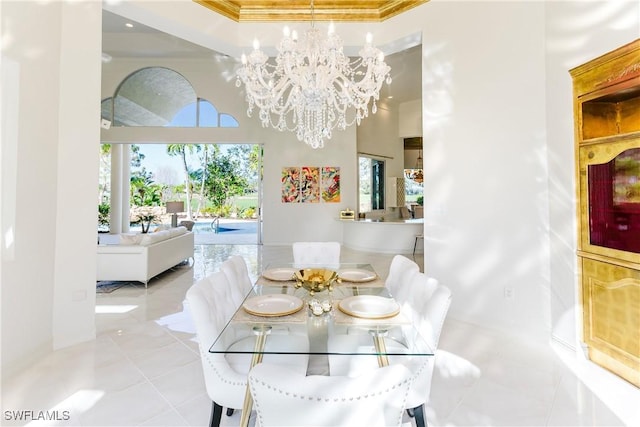 dining area with plenty of natural light, light tile patterned floors, ornamental molding, and a notable chandelier