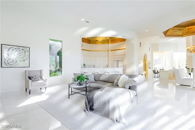 living room featuring a towering ceiling and light tile patterned flooring