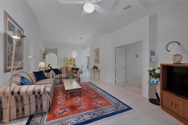 living room featuring ceiling fan, lofted ceiling, and light tile patterned floors