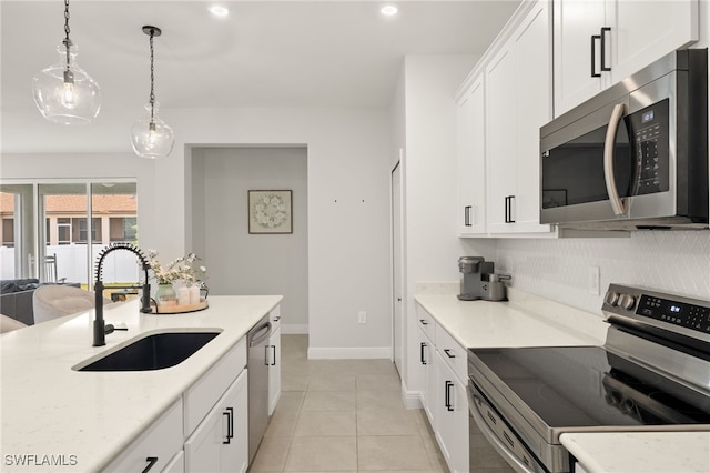 kitchen featuring sink, white cabinetry, appliances with stainless steel finishes, and light tile patterned flooring