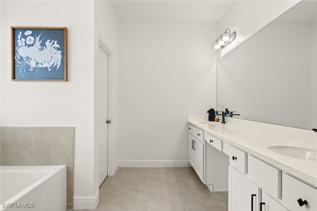 bathroom with tile patterned floors, a bathtub, and vanity