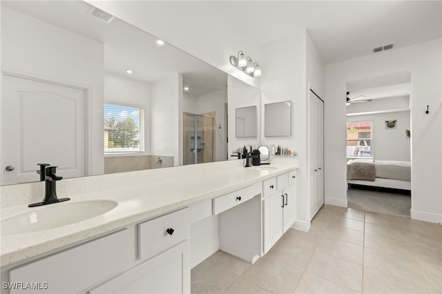 bathroom with walk in shower, vanity, ceiling fan, and tile patterned flooring