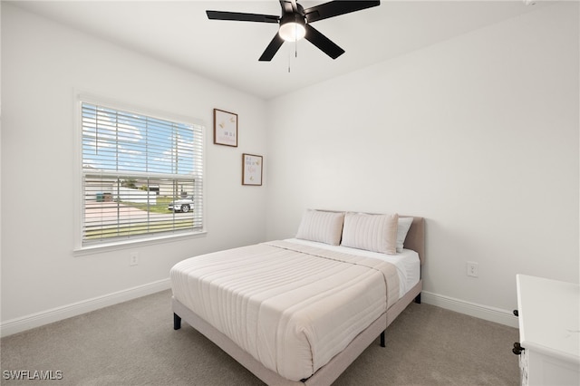 bedroom with ceiling fan and light colored carpet