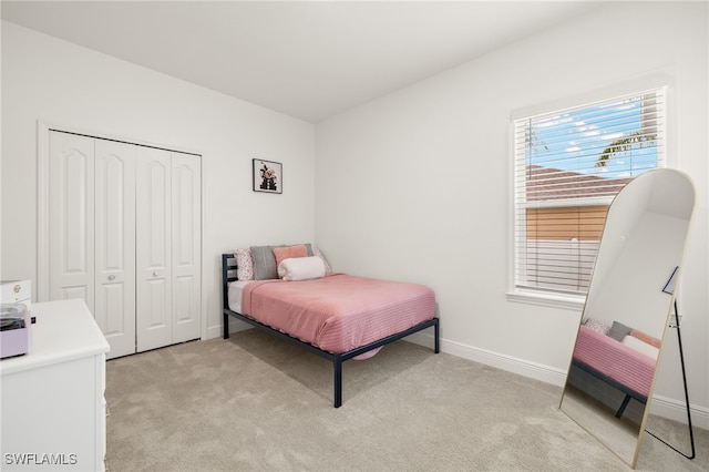 carpeted bedroom featuring a closet