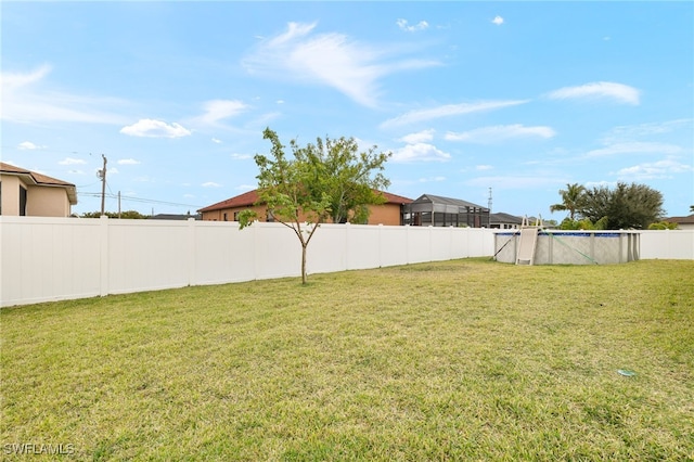 view of yard with a fenced in pool