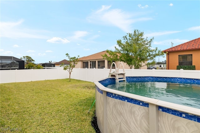 view of pool featuring a lawn