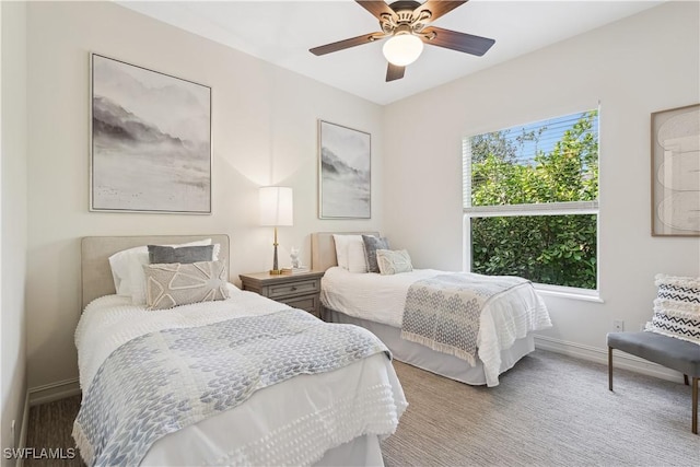 bedroom featuring ceiling fan, carpet, and multiple windows