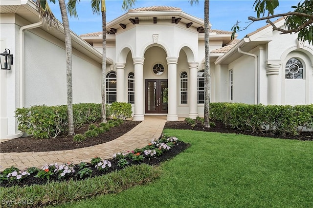 677 5th Ave N, Naples, FL 34102 - entrance to property with french doors, stucco siding, and a yard