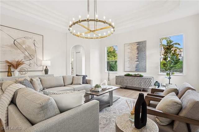 677 5th Ave N, Naples, FL 34102 - living room with arched walkways, light wood-type flooring, and a chandelier