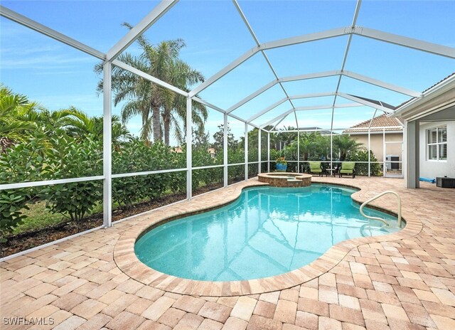 view of pool featuring an in ground hot tub, a patio area, and a lanai