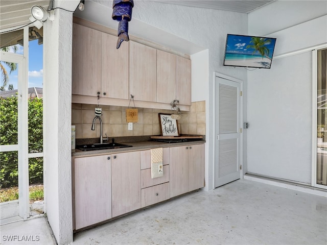 kitchen featuring decorative backsplash, sink, and light brown cabinets