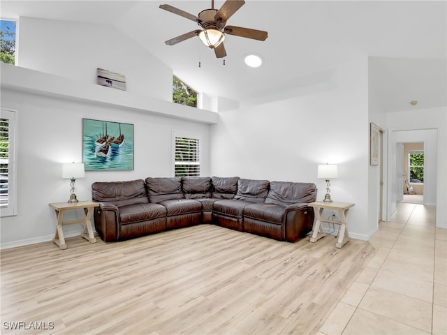 living room featuring ceiling fan, a wealth of natural light, and high vaulted ceiling