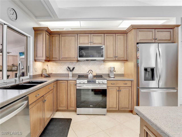 kitchen with light tile patterned flooring, stainless steel appliances, tasteful backsplash, and sink