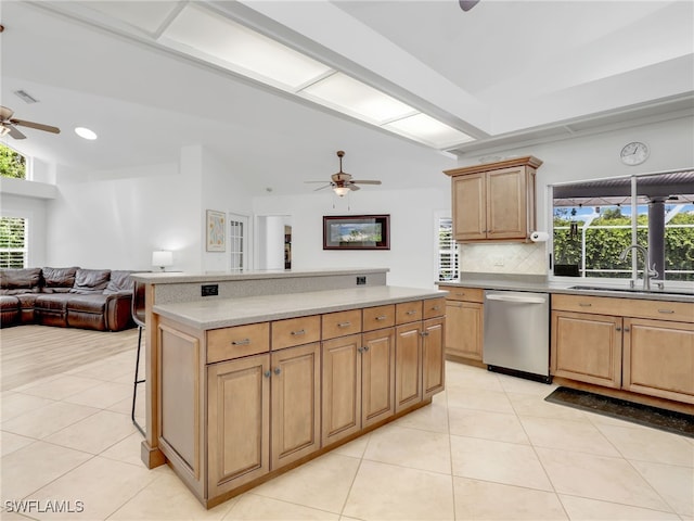 kitchen featuring backsplash, stainless steel dishwasher, sink, light tile patterned flooring, and a kitchen breakfast bar