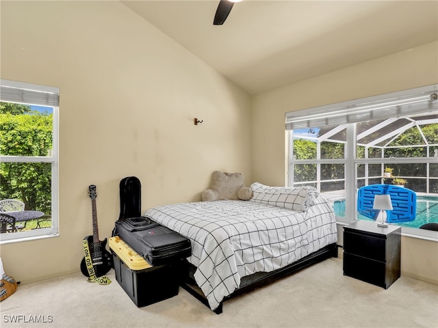 carpeted bedroom with ceiling fan and vaulted ceiling