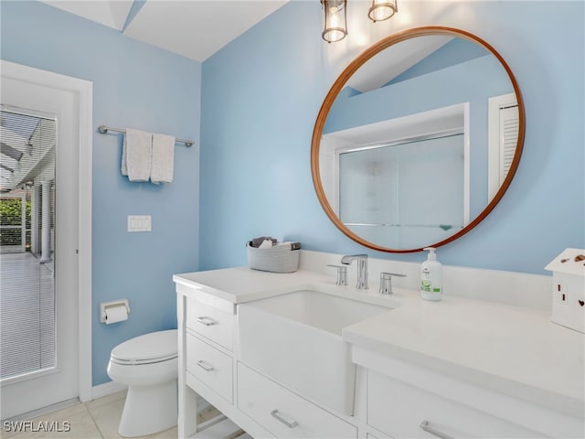 bathroom with toilet, vanity, tile patterned flooring, and a shower with shower door