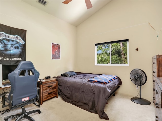 carpeted bedroom with ceiling fan and vaulted ceiling