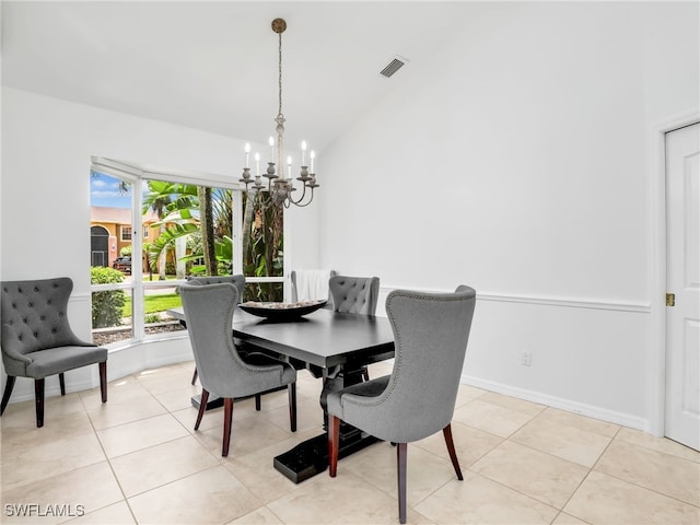 dining area featuring vaulted ceiling, an inviting chandelier, and light tile patterned floors