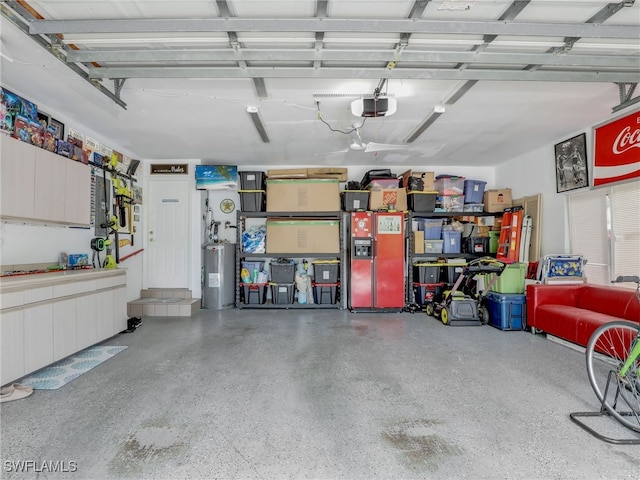 garage with a garage door opener and electric water heater