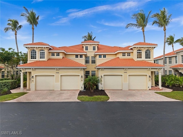 mediterranean / spanish-style house with a garage