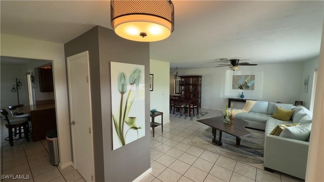 tiled living room featuring ceiling fan