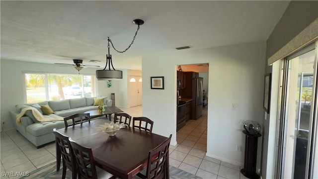 dining area with ceiling fan and light tile patterned floors