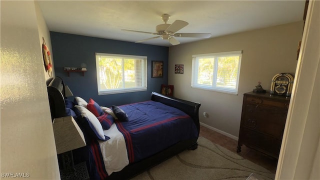 bedroom with ceiling fan, carpet, and multiple windows