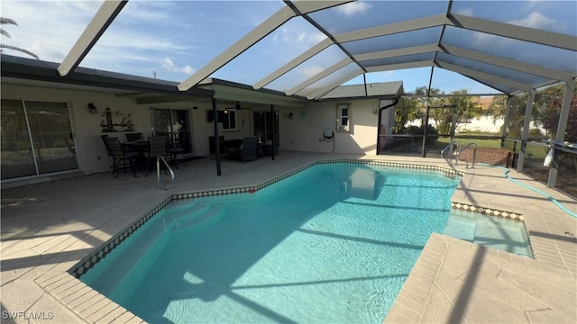 view of swimming pool featuring a patio area, a lanai, and ceiling fan