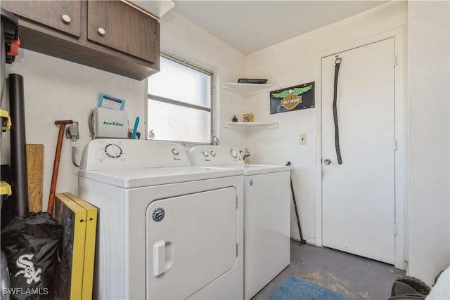 washroom with cabinets and washing machine and clothes dryer