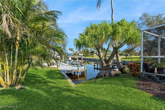 dock area featuring glass enclosure and a lawn