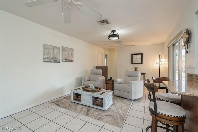 living room with ceiling fan and light tile patterned flooring